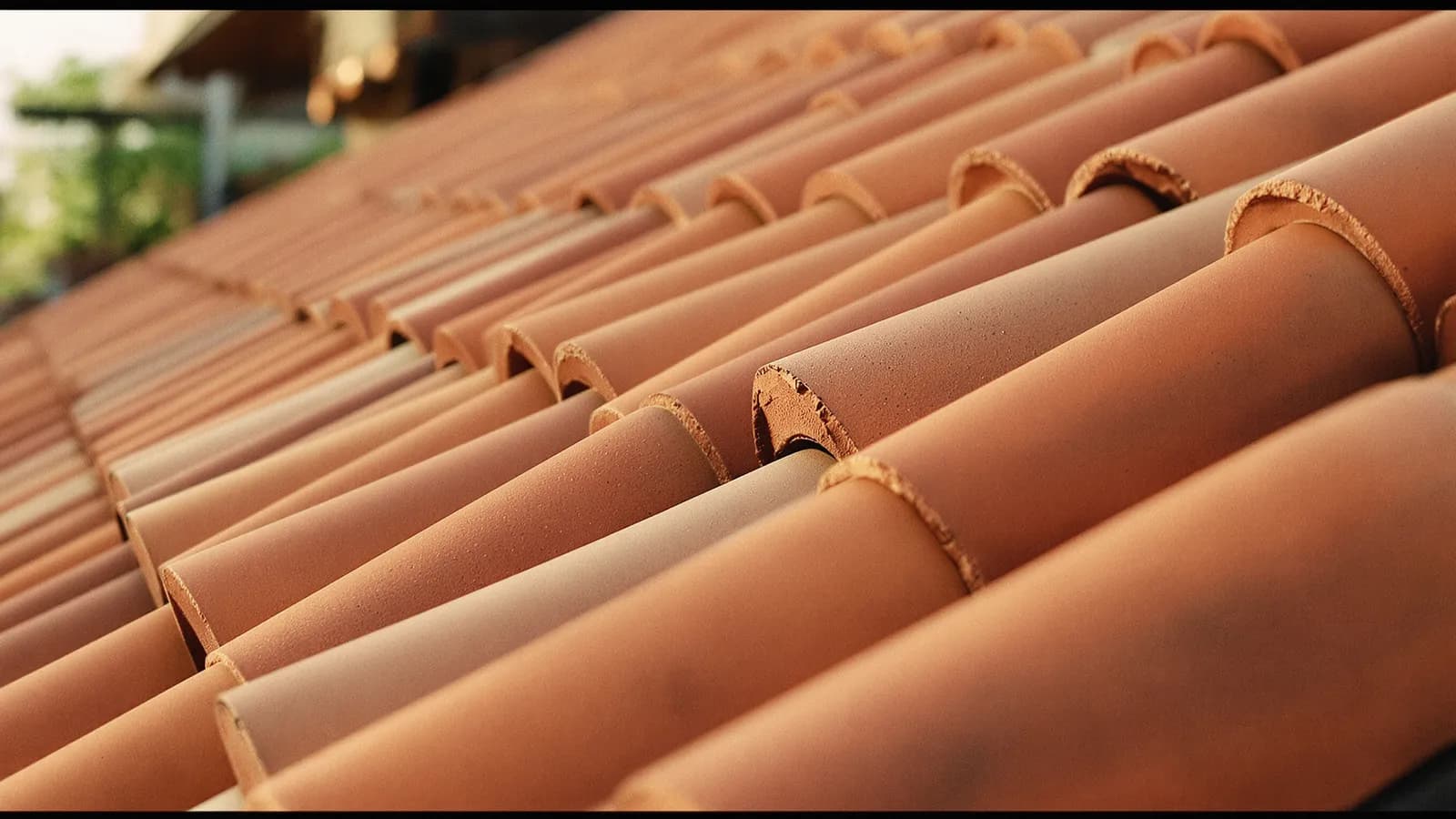 Sun-bleached terracotta roof tiles in warm afternoon light