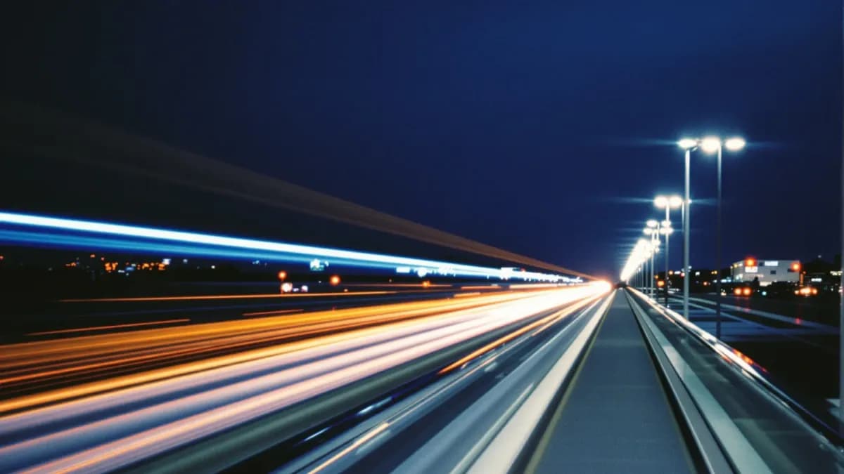 Long exposure of an empty airport walkway at night with light trails